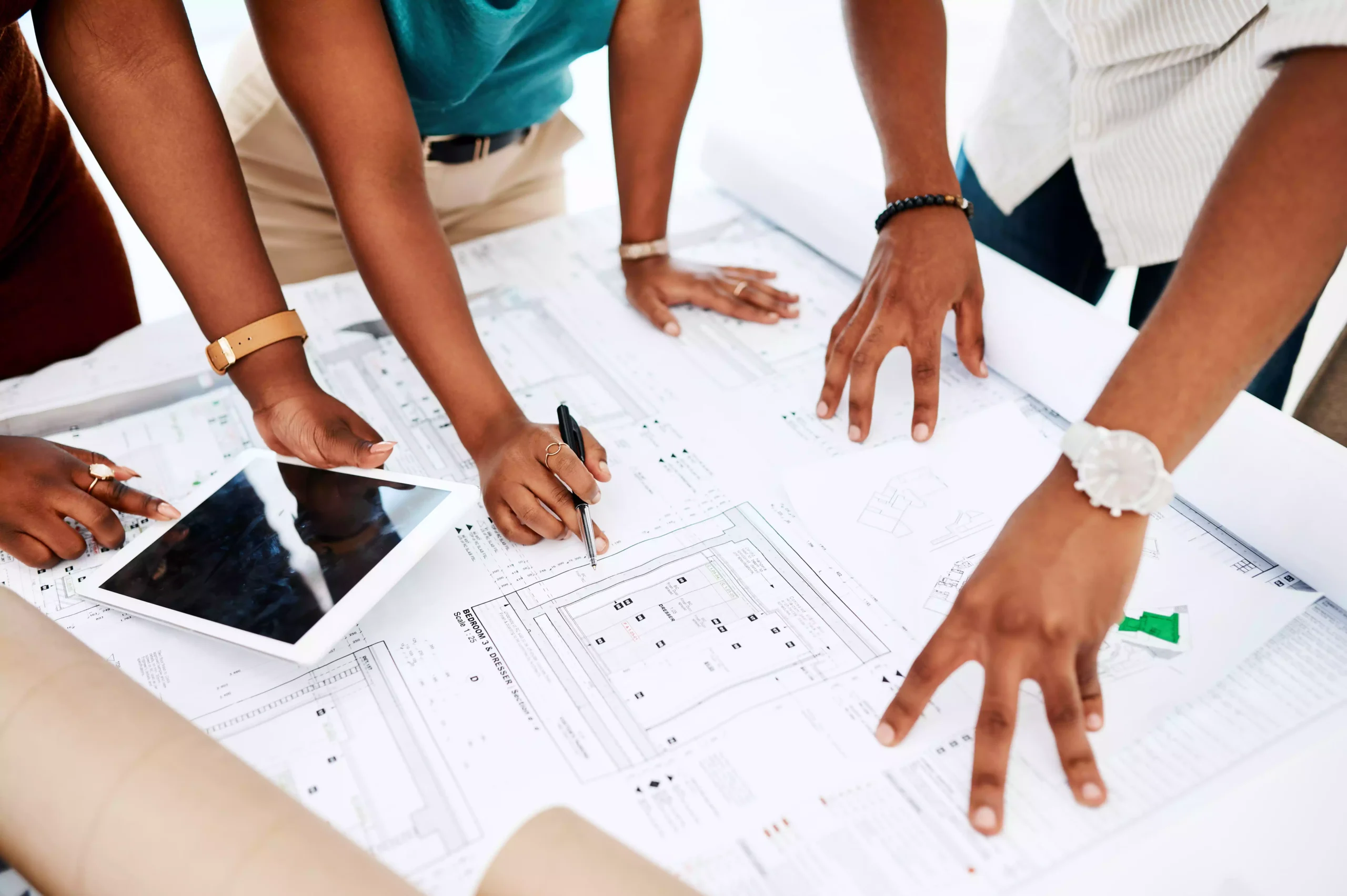 cropped shot of a group of colleagues going over construction plan